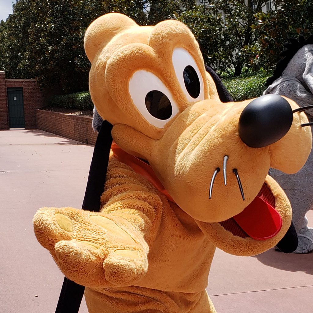 Goofy character holding out paw