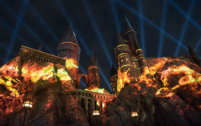 Hogwarts illuminated at night orange and red lights