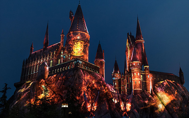 Hogwarts illuminated at night red Gryffindor lights