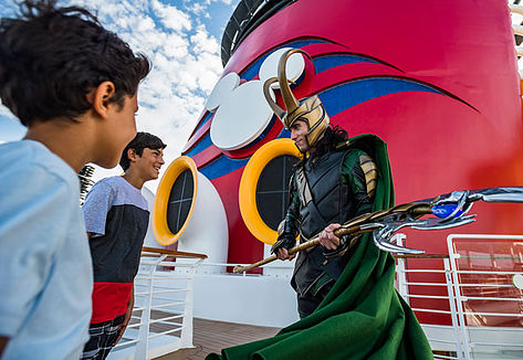 Loki talking to two boys on cruise ship deck
