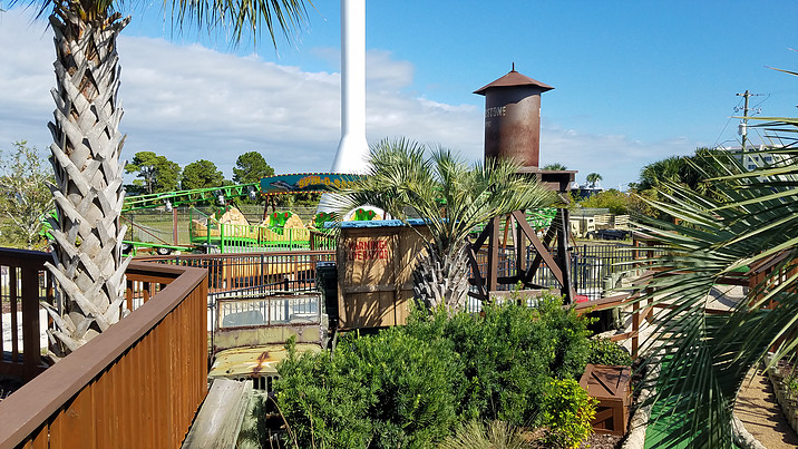 Rides and palm trees at Wild Willys Dino Adventure