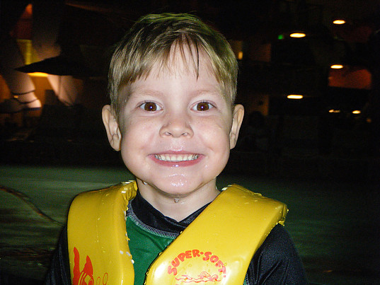 child smiling wearing life vest