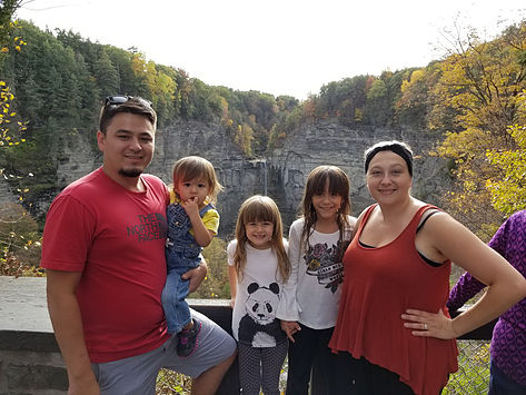 family posing in front of gorge in Ithaca