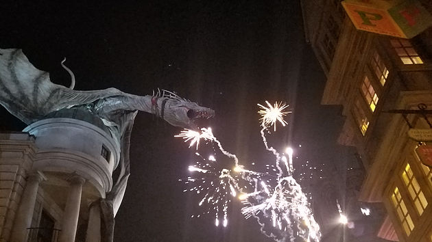fireworks by statue of Gringott's dragon