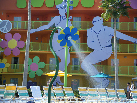large dancing figure cutouts by the pool