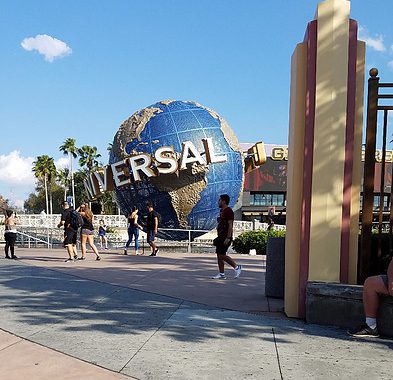 people walking by the Universal Orlando Globe