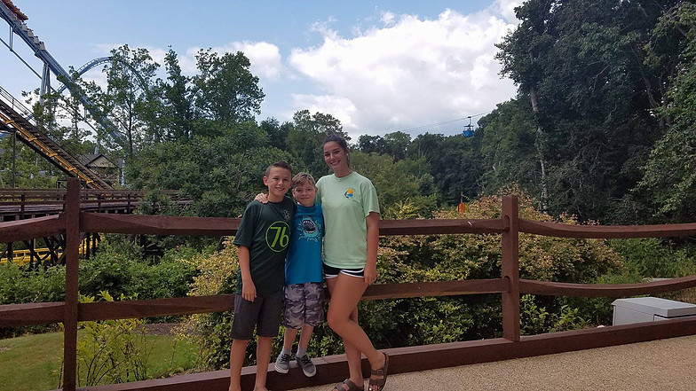 three kids posing in front of roller coaster at Busch Gardens Williamsburg